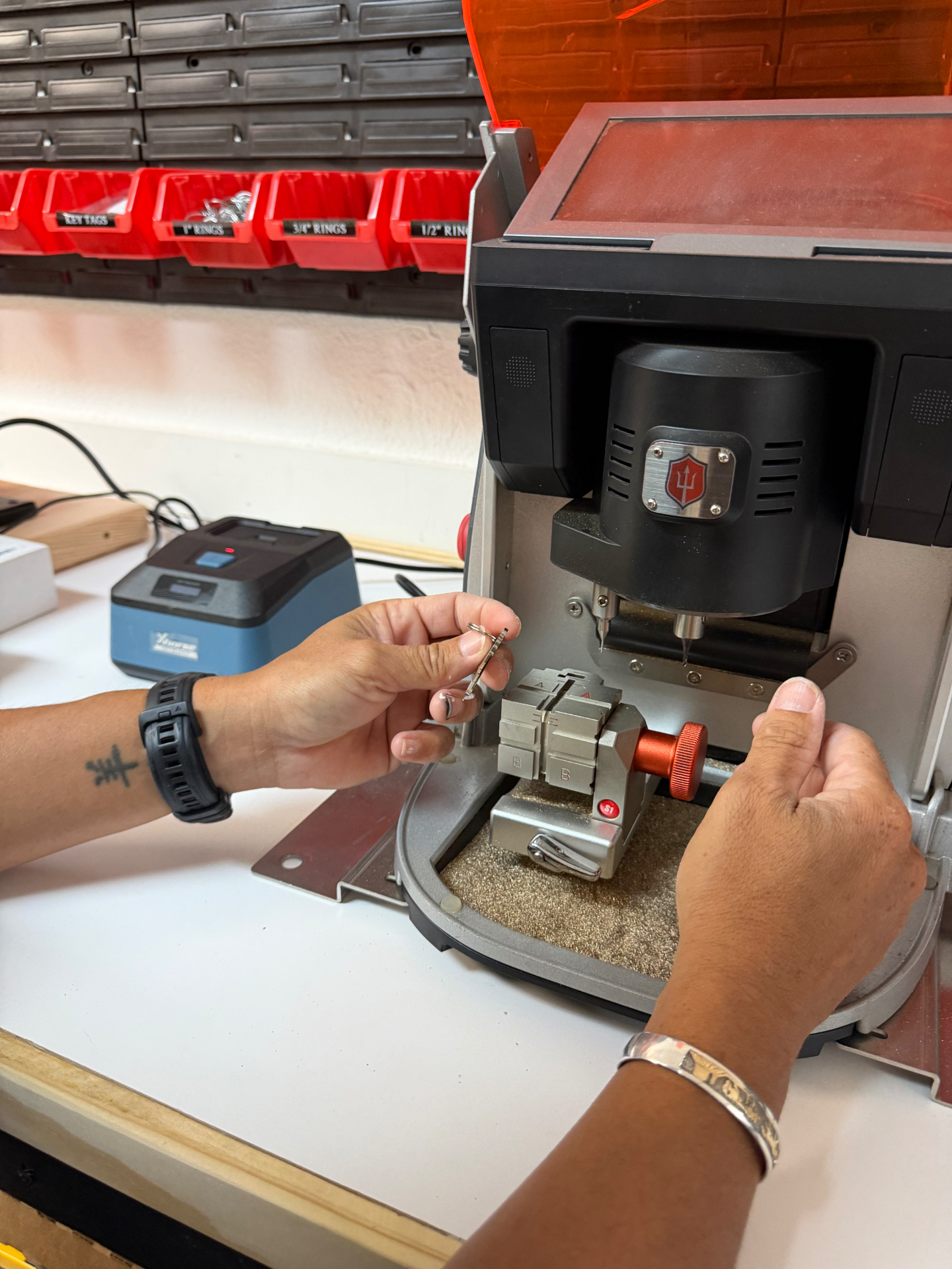 Close-up of automotive key being cut on a precision key machine